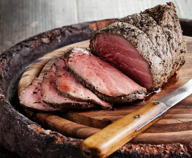 Roast beef on cutting board and knife