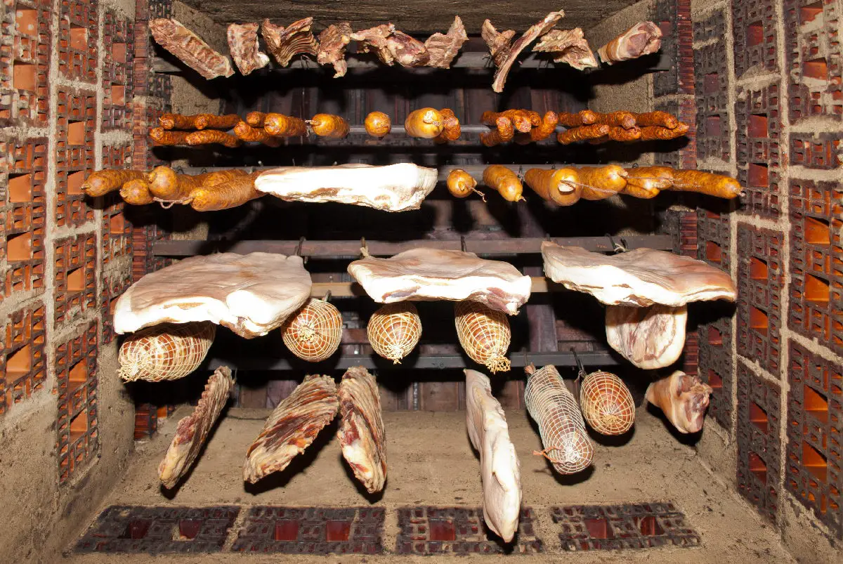 Smoked meat hanging in domestic smokehouse.