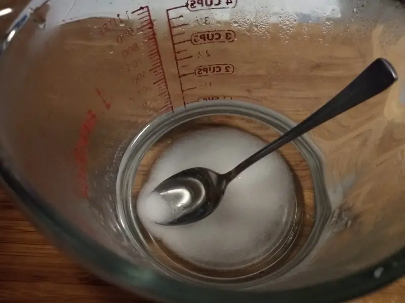  dissolve pickling salt in two cups of hot water