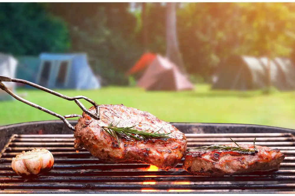 Roasted beef ripe steaks on flaming charcoal grill