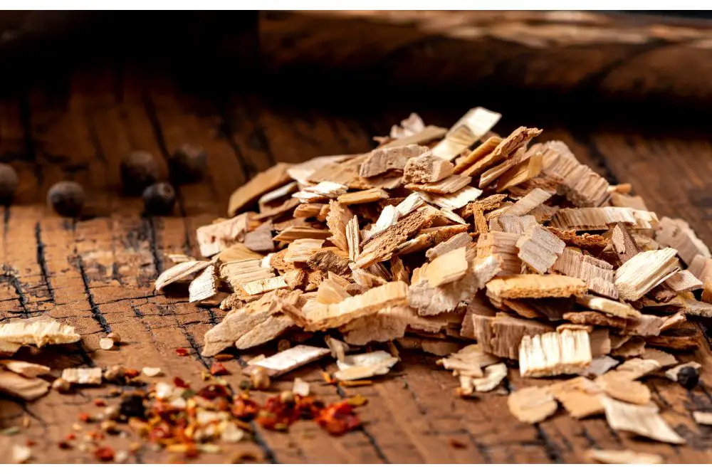 Wood chips for smoking meat or fish on an old wooden table