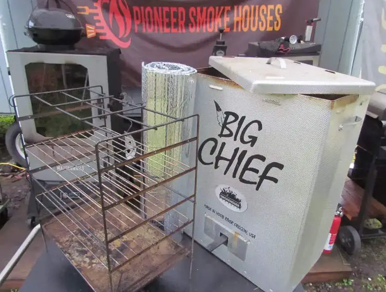 Parts of a Big Chief Electric Smoker on an outdoor table
