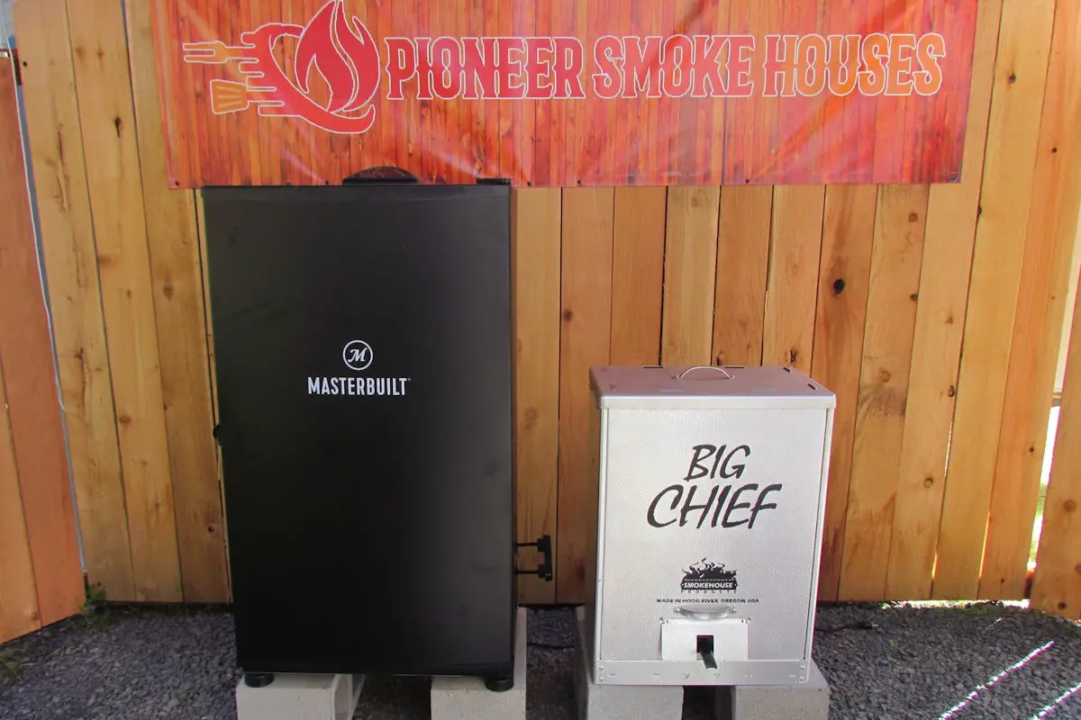 Big Chief electric smoker next to a Masterbuilt electric smoker, on the Pioneer Smoke Houses stage.