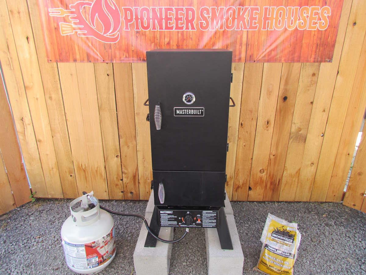 A Masterbuilt propane smoker on the pioneer smoke houses stage