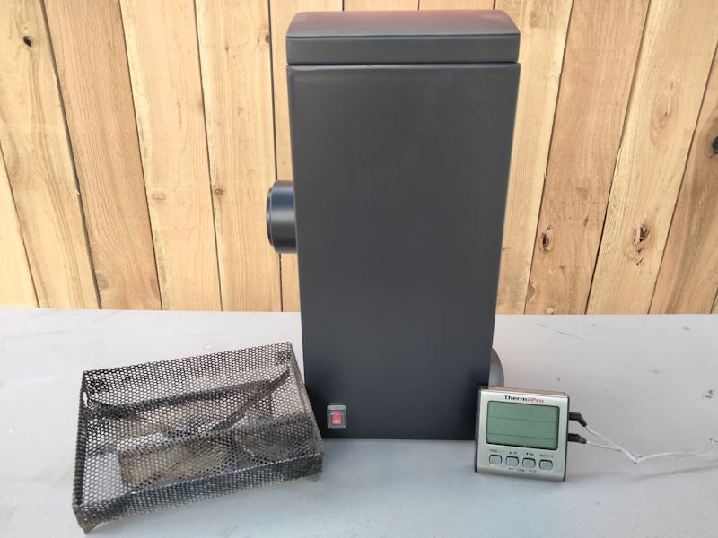 Masterbuilt smoker accessories including a thermometer, pellet smoke tray, and a Masterbuilt smoke attachment by Robert of pioneer smoke houses
