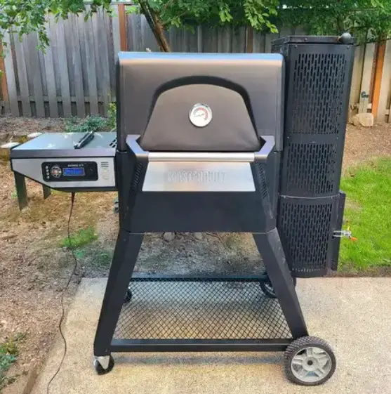 A Masterbuilt 560 smoker placed outside for review by Pioneer Smoke Houses.
