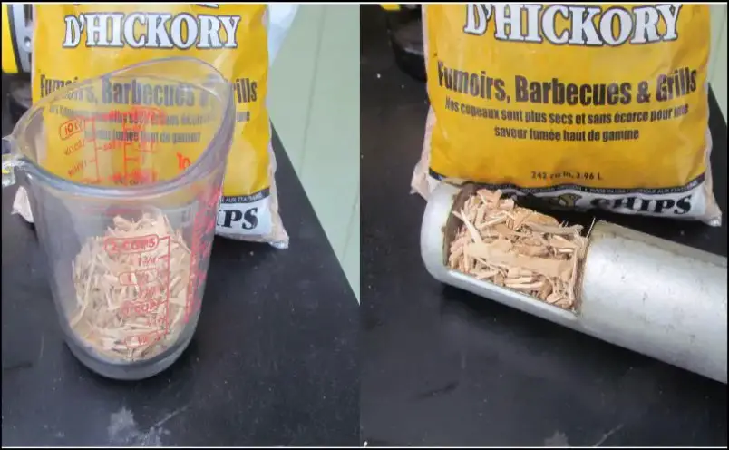 Wood chips being measured and put into the Masterbuilt Electric Smoker’s loading tube.