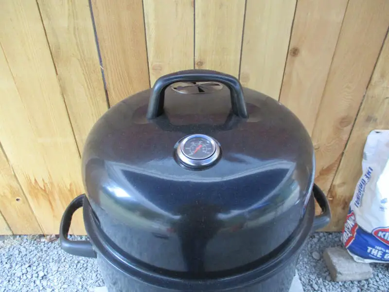 Lid Handle and Temperature Gauge of a Masterbuilt Charcoal bullet smoker